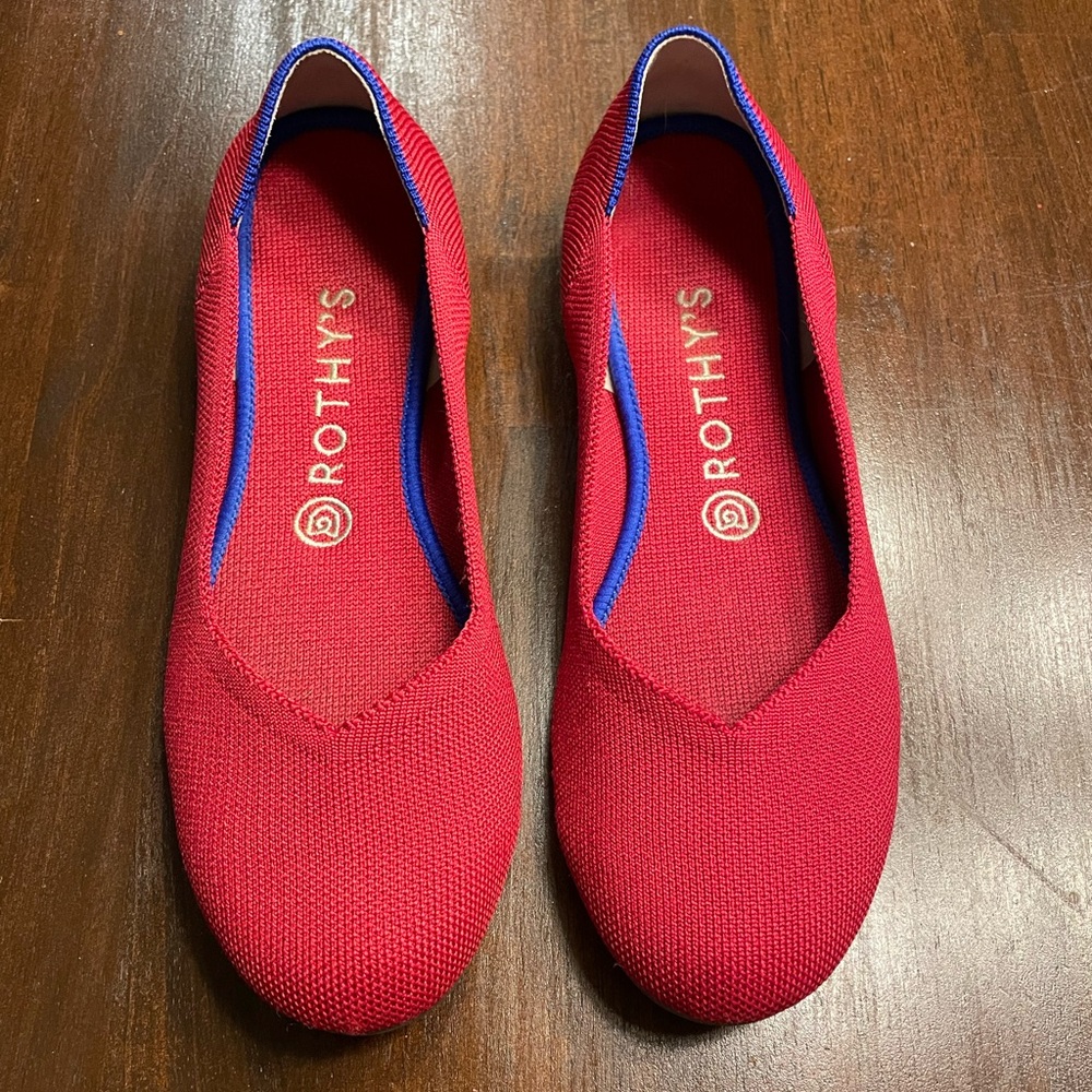 Rothy’s chili red ballet flats with royal blue trim.